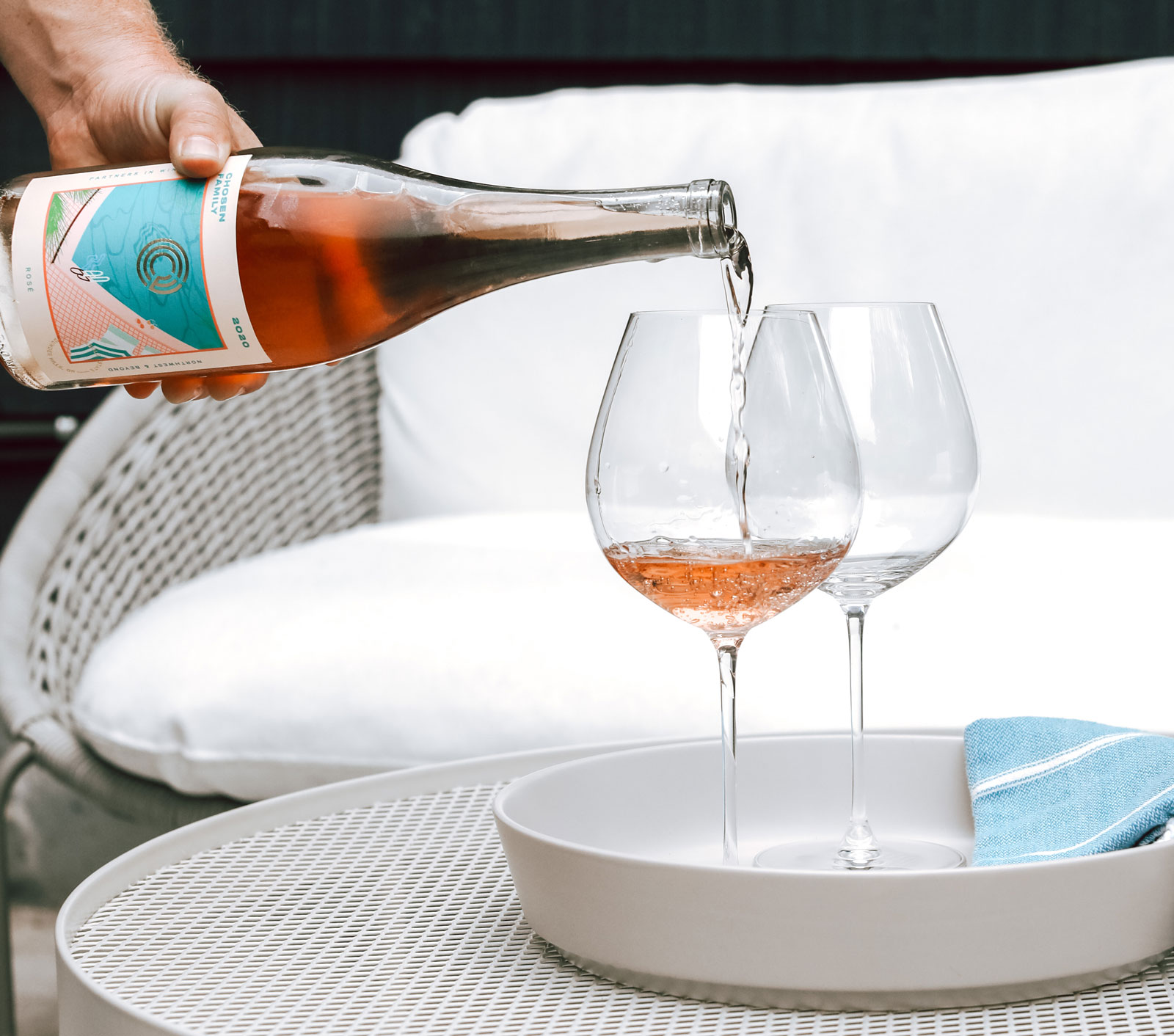 Pouring a bottle of Chosen Family Wines Rosé into two glasses